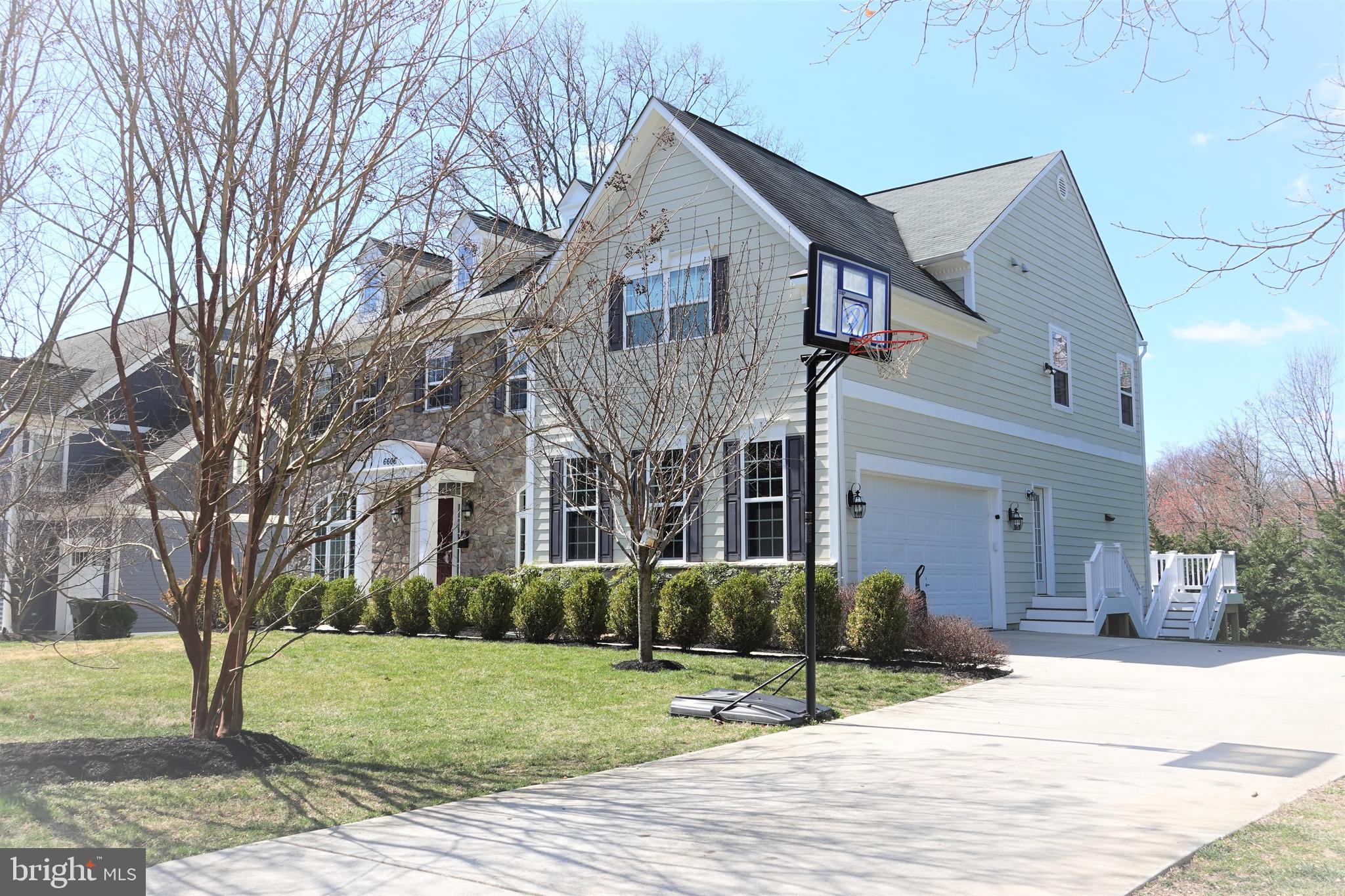 6606 Pyle Road Bethesda, MD 20817 - Photo 2 of 29 a view of a brick house with a yard and large tree