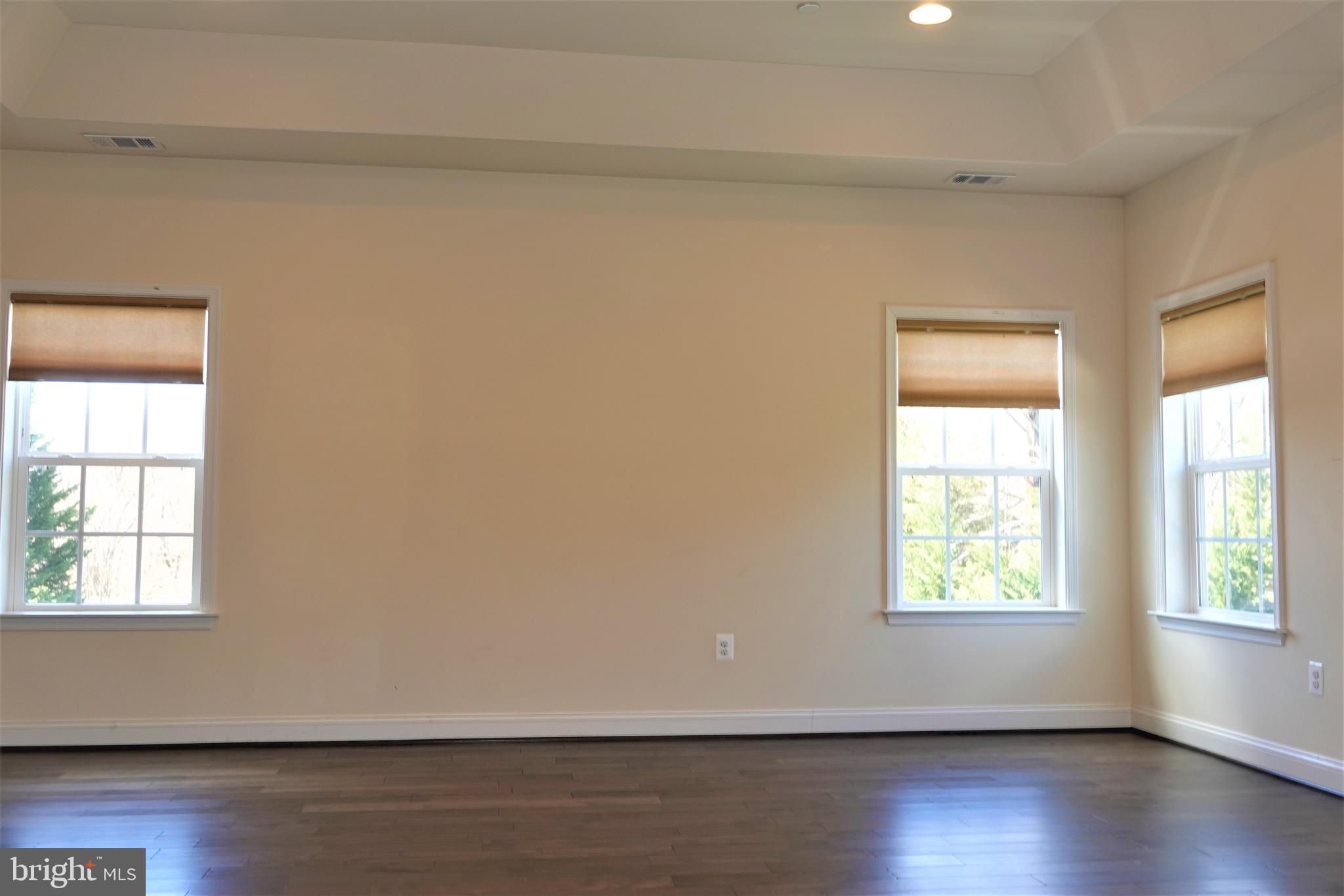 6606 Pyle Road Bethesda, MD 20817 - Photo 23 of 29 an empty room with wooden floor and windows