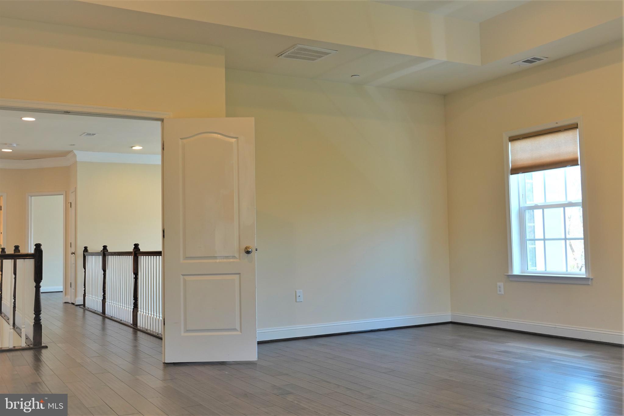 6606 Pyle Road Bethesda, MD 20817 - Photo 24 of 29 an empty room with wooden floor and a window