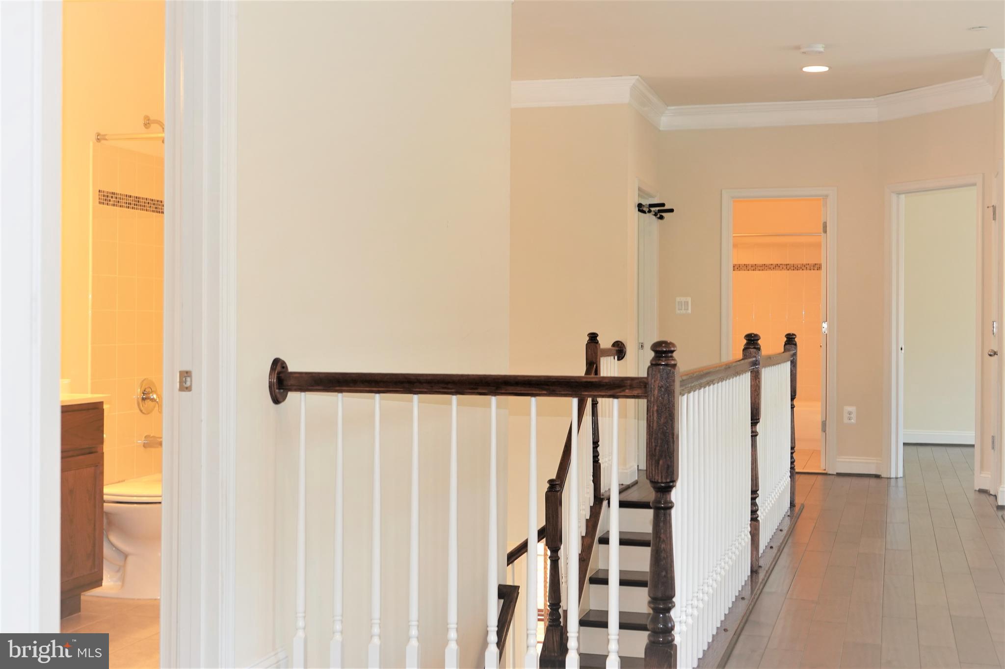6606 Pyle Road Bethesda, MD 20817 - Photo 25 of 29 a view of a hallway with wooden floor and staircase