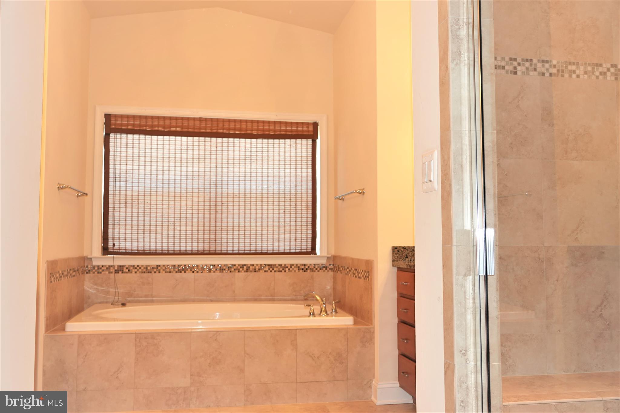 6606 Pyle Road Bethesda, MD 20817 - Photo 26 of 29 a bathroom with a bathtub and a shower