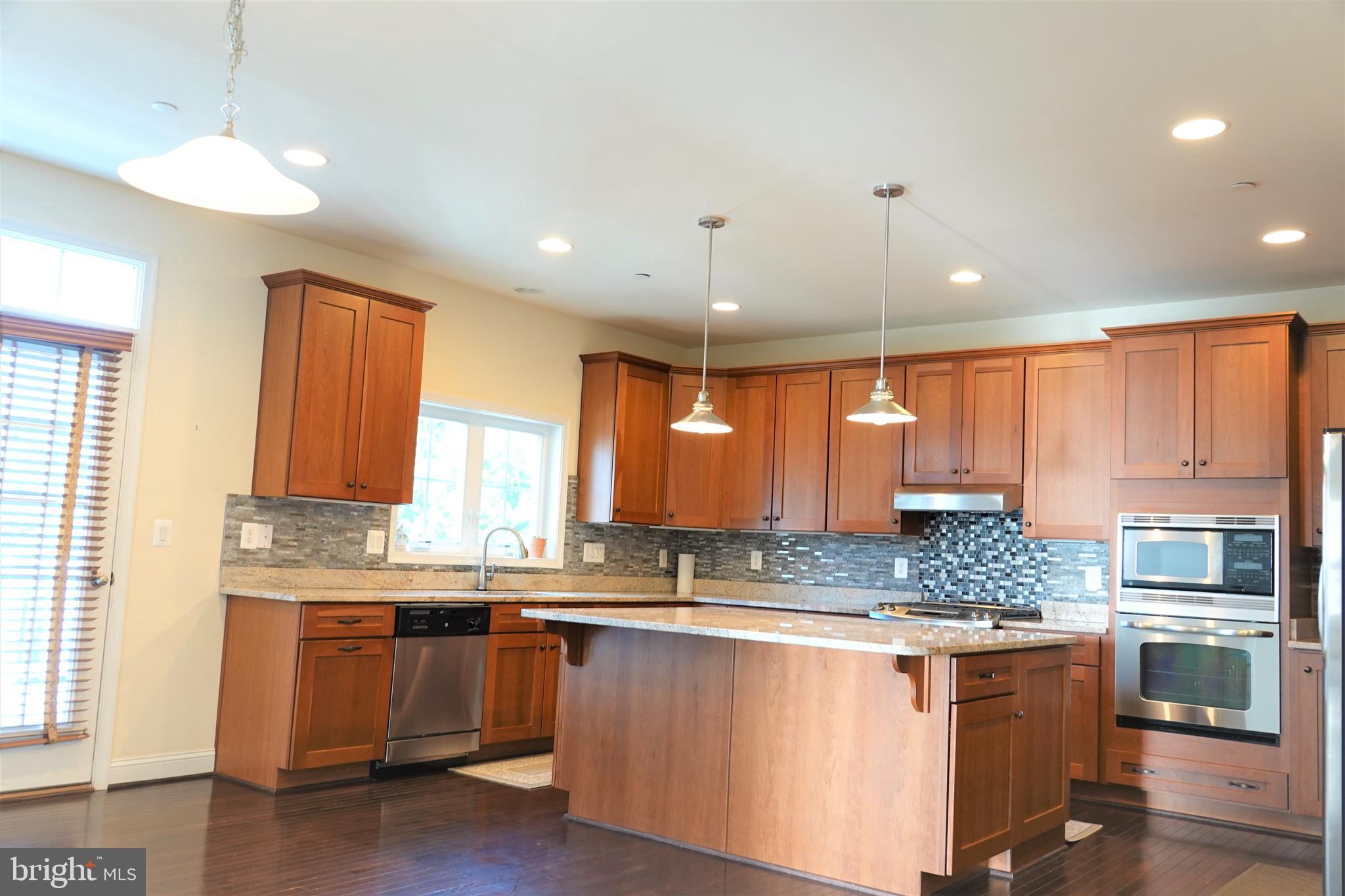 6606 Pyle Road Bethesda, MD 20817 - Photo 8 of 29 a kitchen with stainless steel appliances granite countertop a stove a sink and a microwave