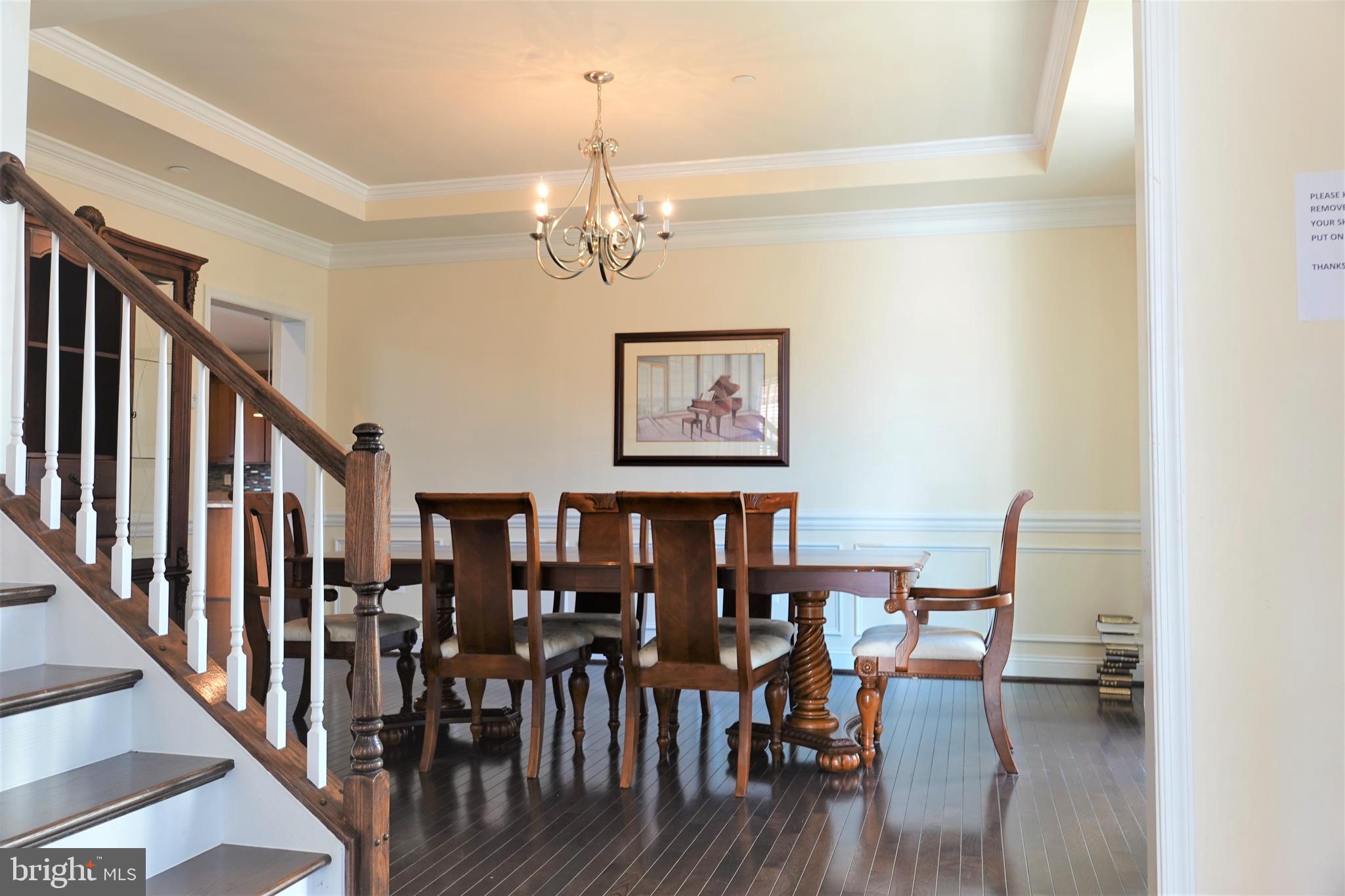 6606 Pyle Road Bethesda, MD 20817 - Photo 10 of 29 a view of a dining room with furniture wooden floor and chandelier