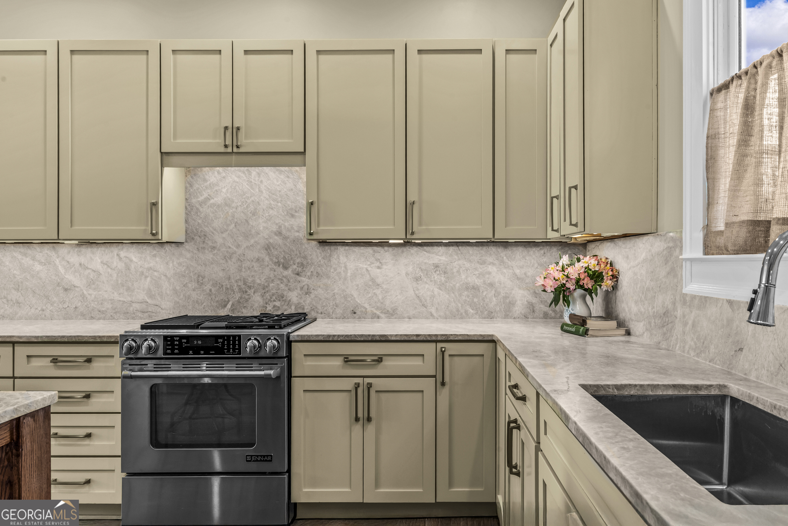 568 New Post Road Madison, GA 30650 - Photo 12 of 58 a kitchen with granite countertop white cabinets and stainless steel appliances