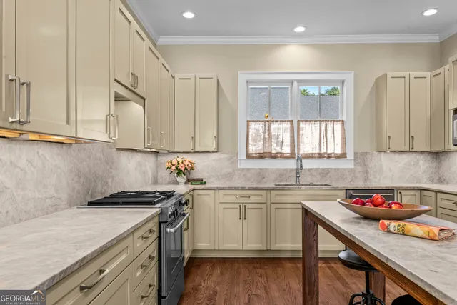 a kitchen with stainless steel appliances granite countertop a sink and a refrigerator