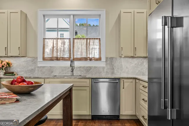a kitchen with a sink a stove and cabinets
