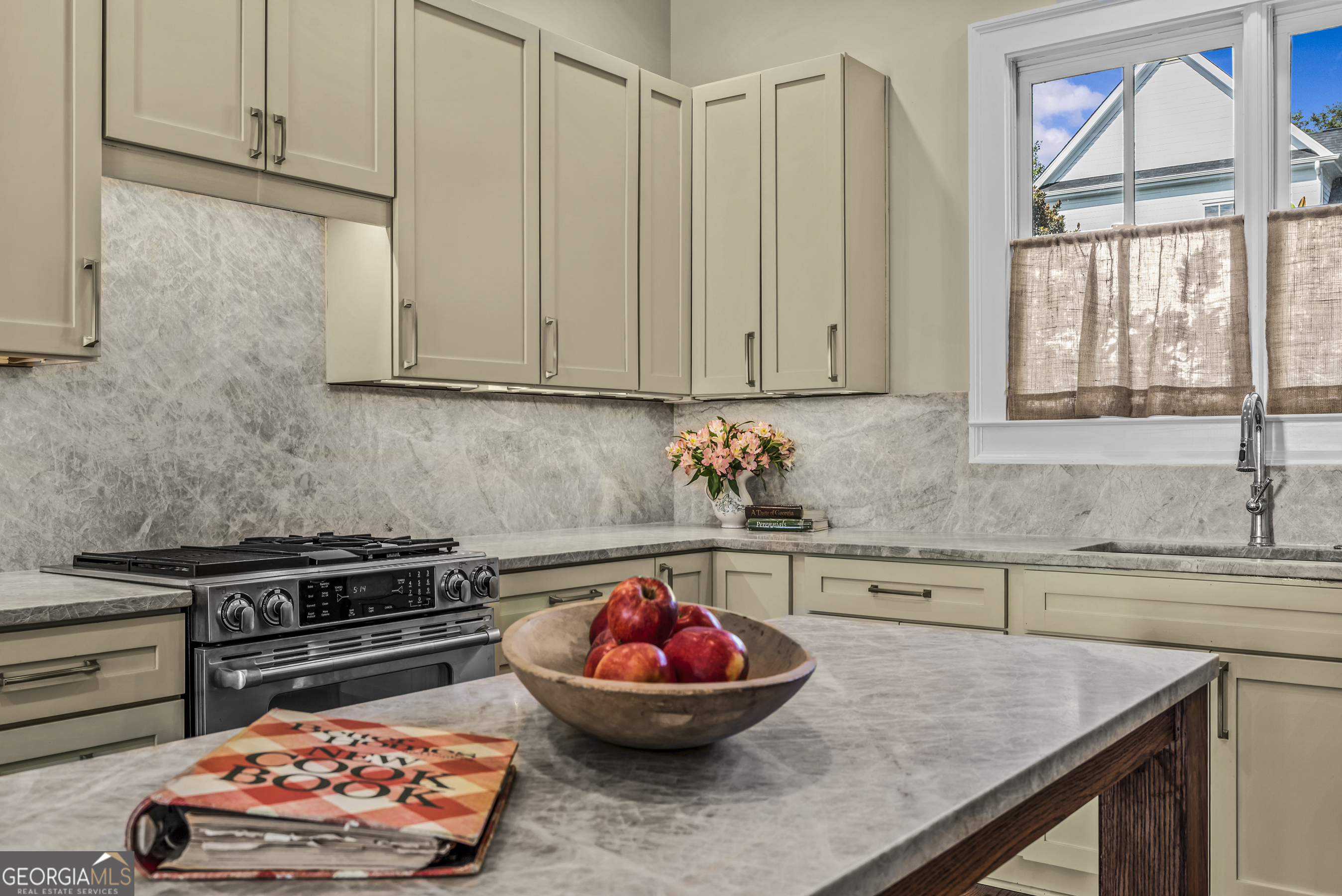 568 New Post Road Madison, GA 30650 - Photo 15 of 58 a kitchen with a sink a stove and cabinets