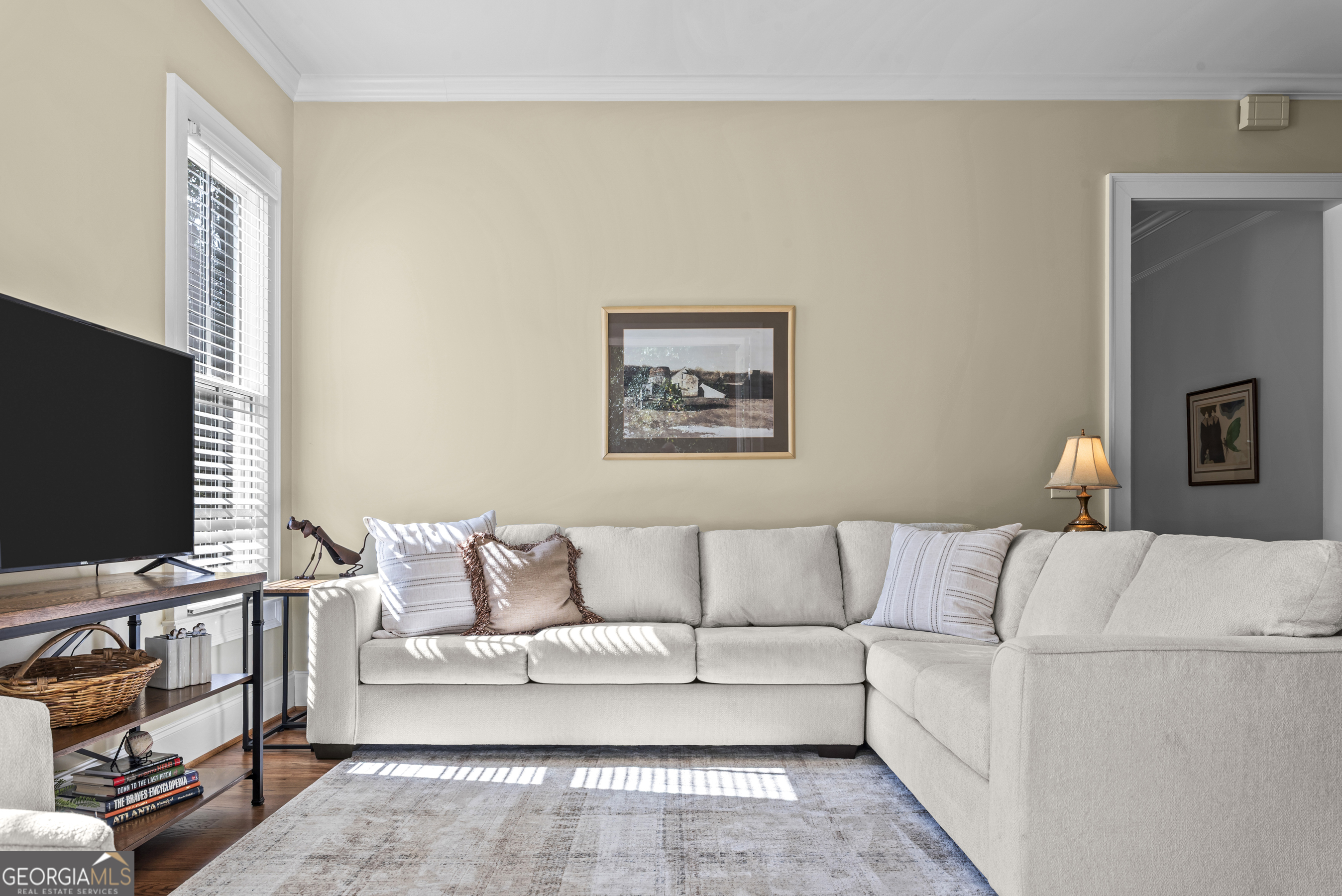 568 New Post Road Madison, GA 30650 - Photo 18 of 58 a living room with furniture and a flat screen tv