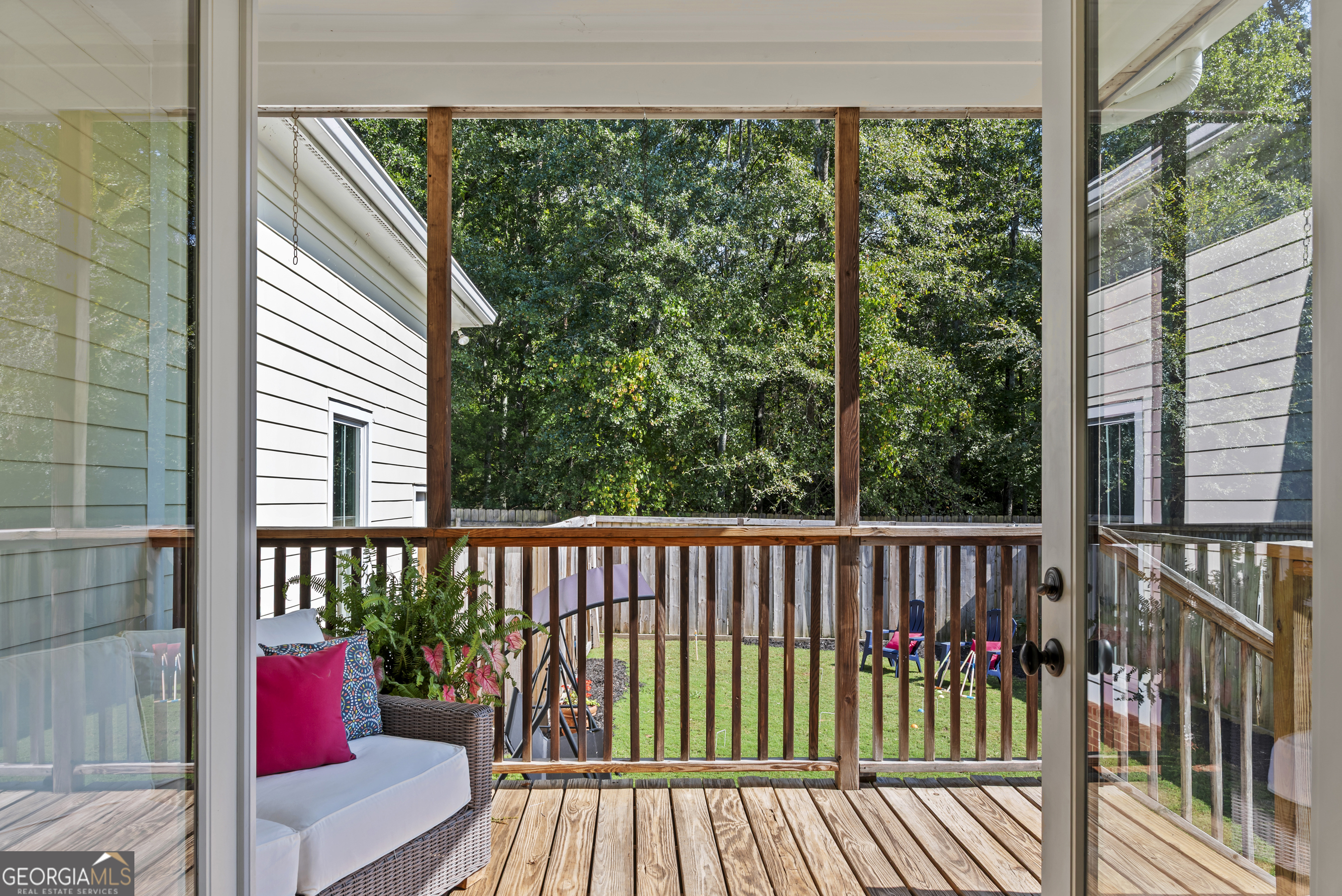 568 New Post Road Madison, GA 30650 - Photo 21 of 58 a porch with a bench next to a yard