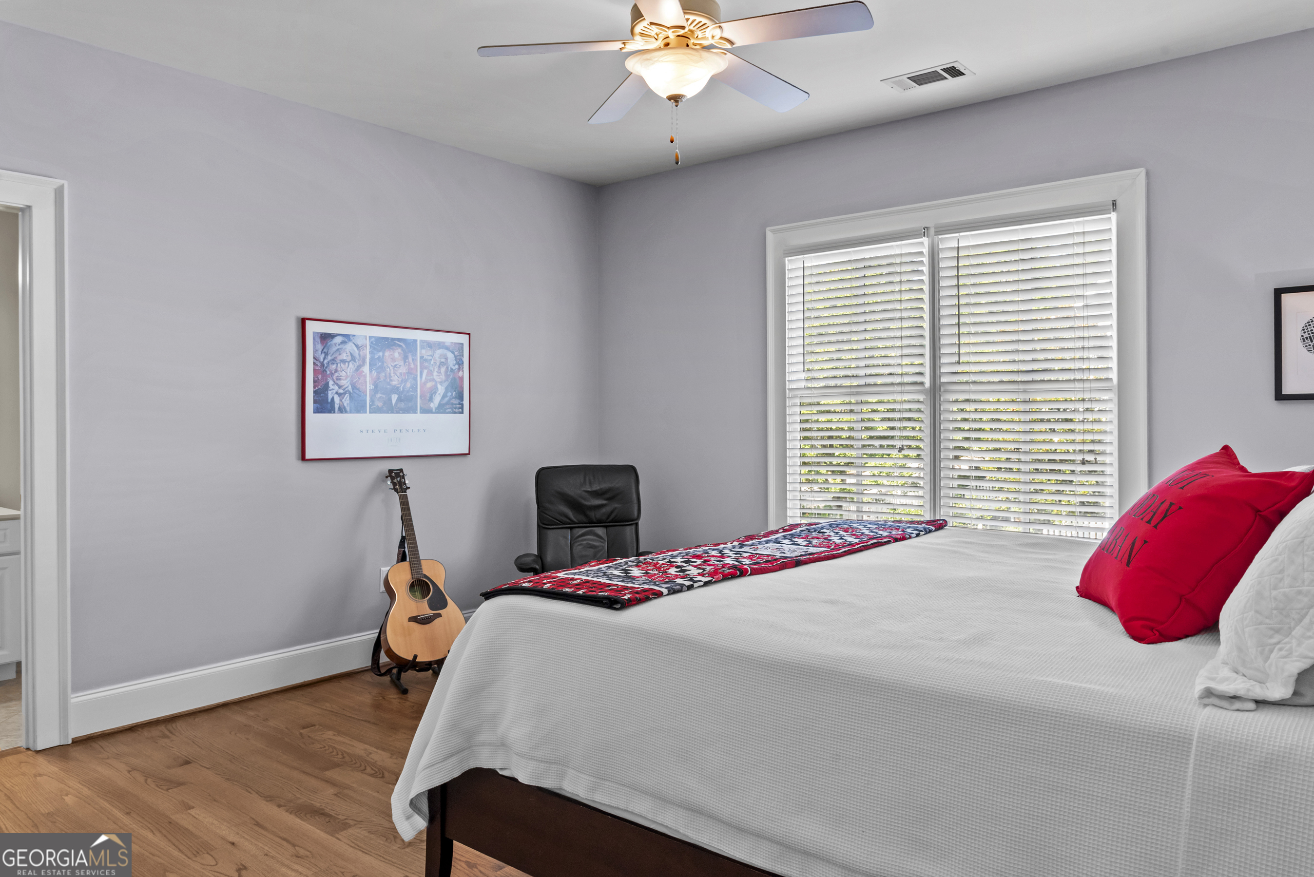 568 New Post Road Madison, GA 30650 - Photo 30 of 58 a bedroom with a bed and a chandelier