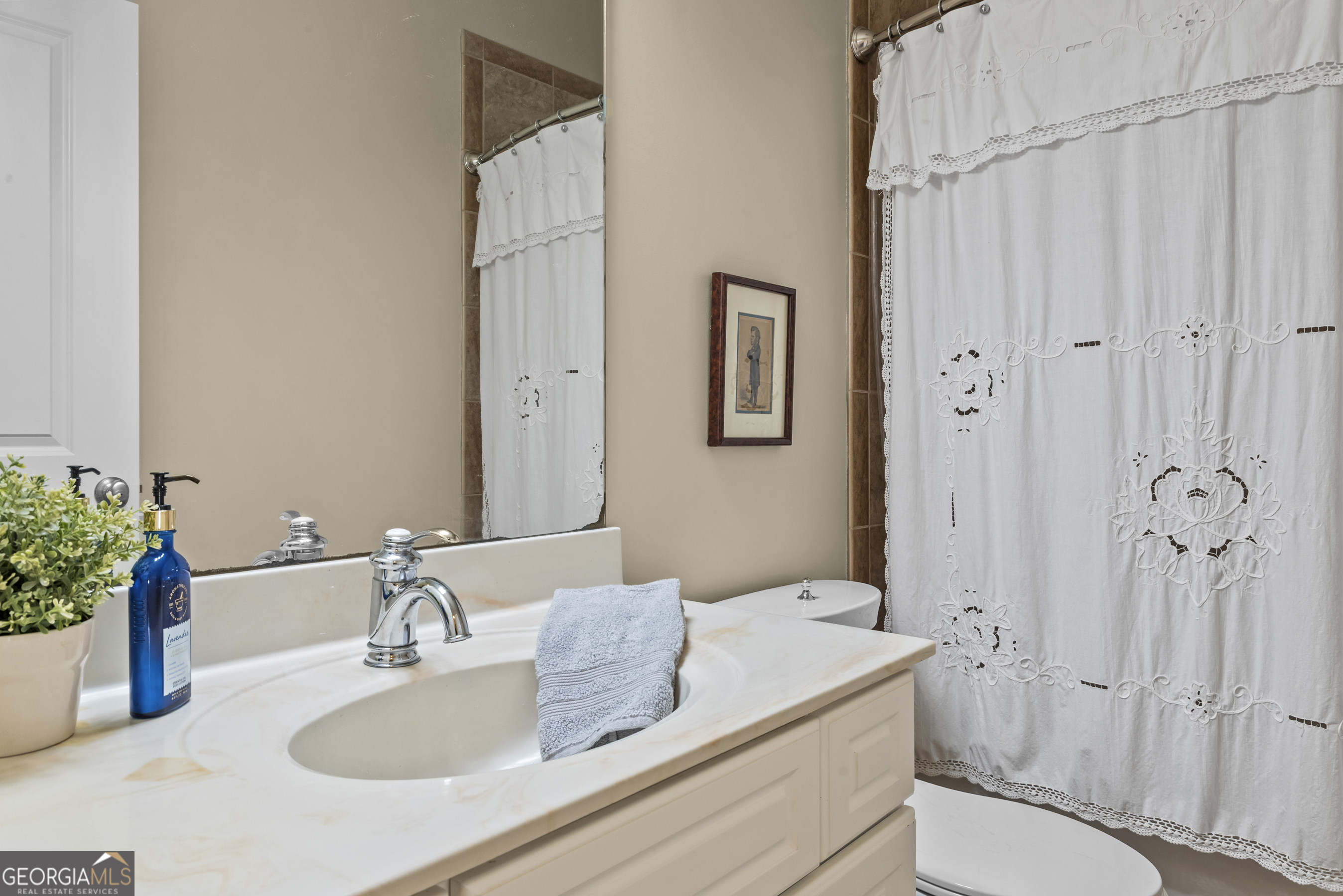 568 New Post Road Madison, GA 30650 - Photo 39 of 58 a bathroom with a granite countertop sink toilet and shower