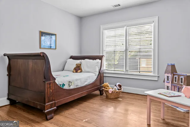 a view of a hallway with wooden floor and entryway