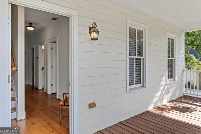 a living room with furniture a flat screen tv and a large window