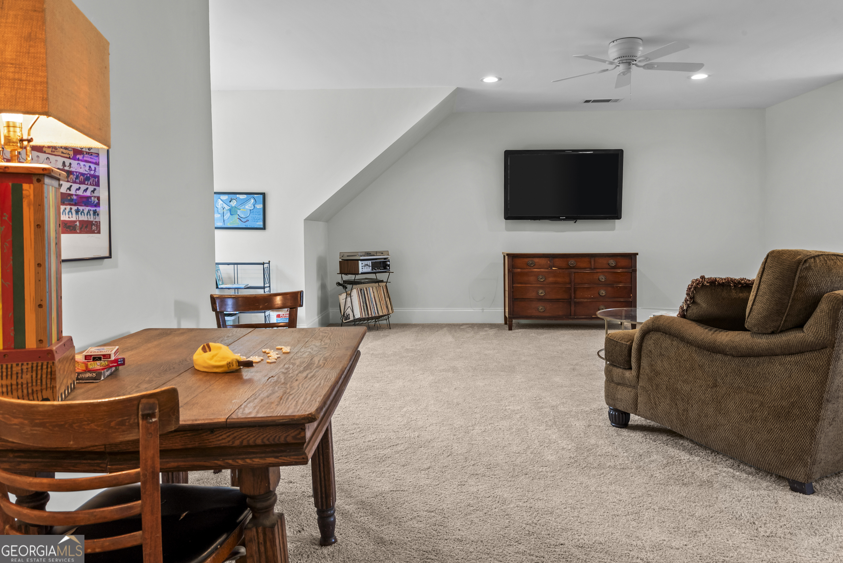 568 New Post Road Madison, GA 30650 - Photo 46 of 58 a living room with furniture a flat screen tv and kitchen view