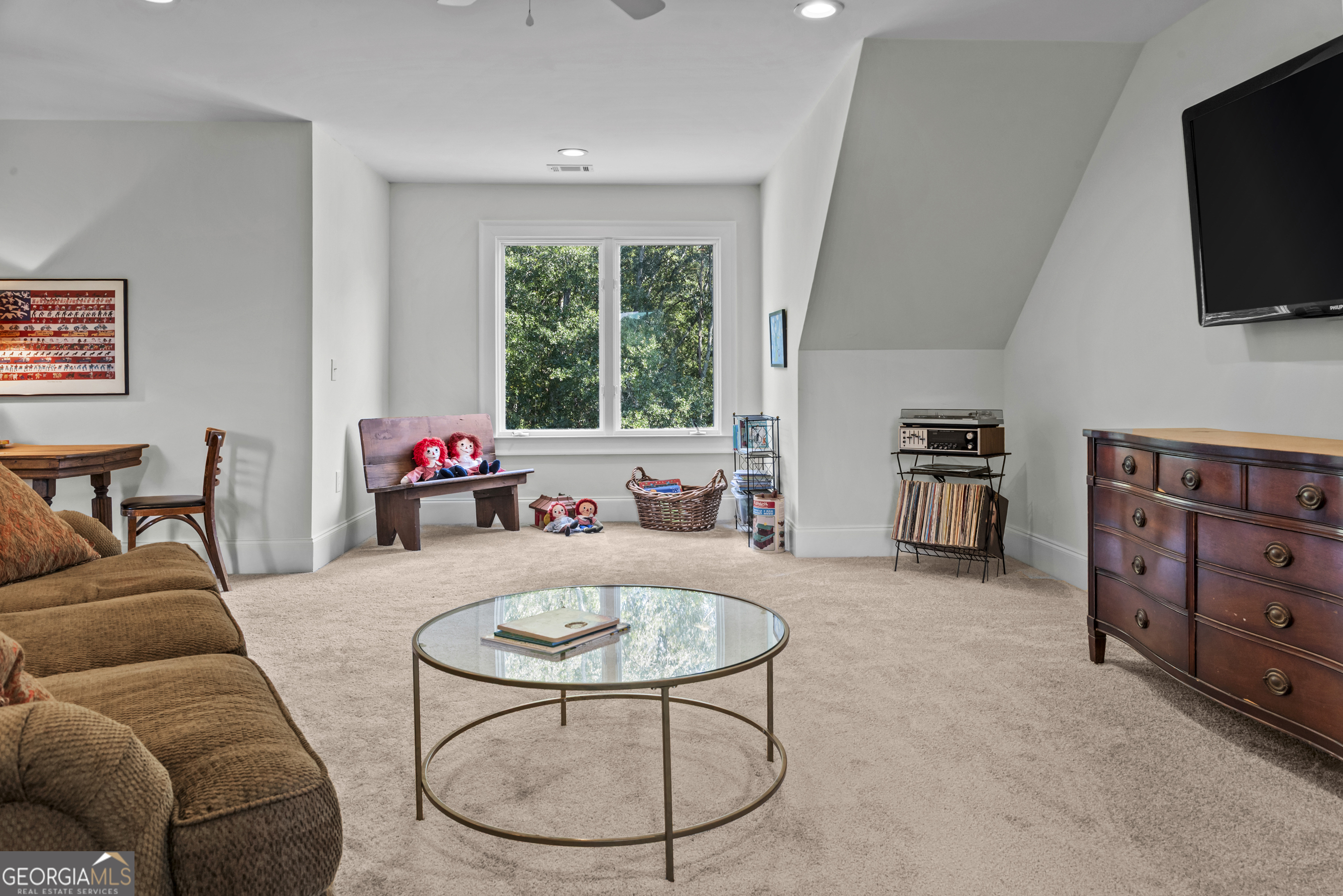 568 New Post Road Madison, GA 30650 - Photo 47 of 58 a living room with furniture a flat screen tv and a large window