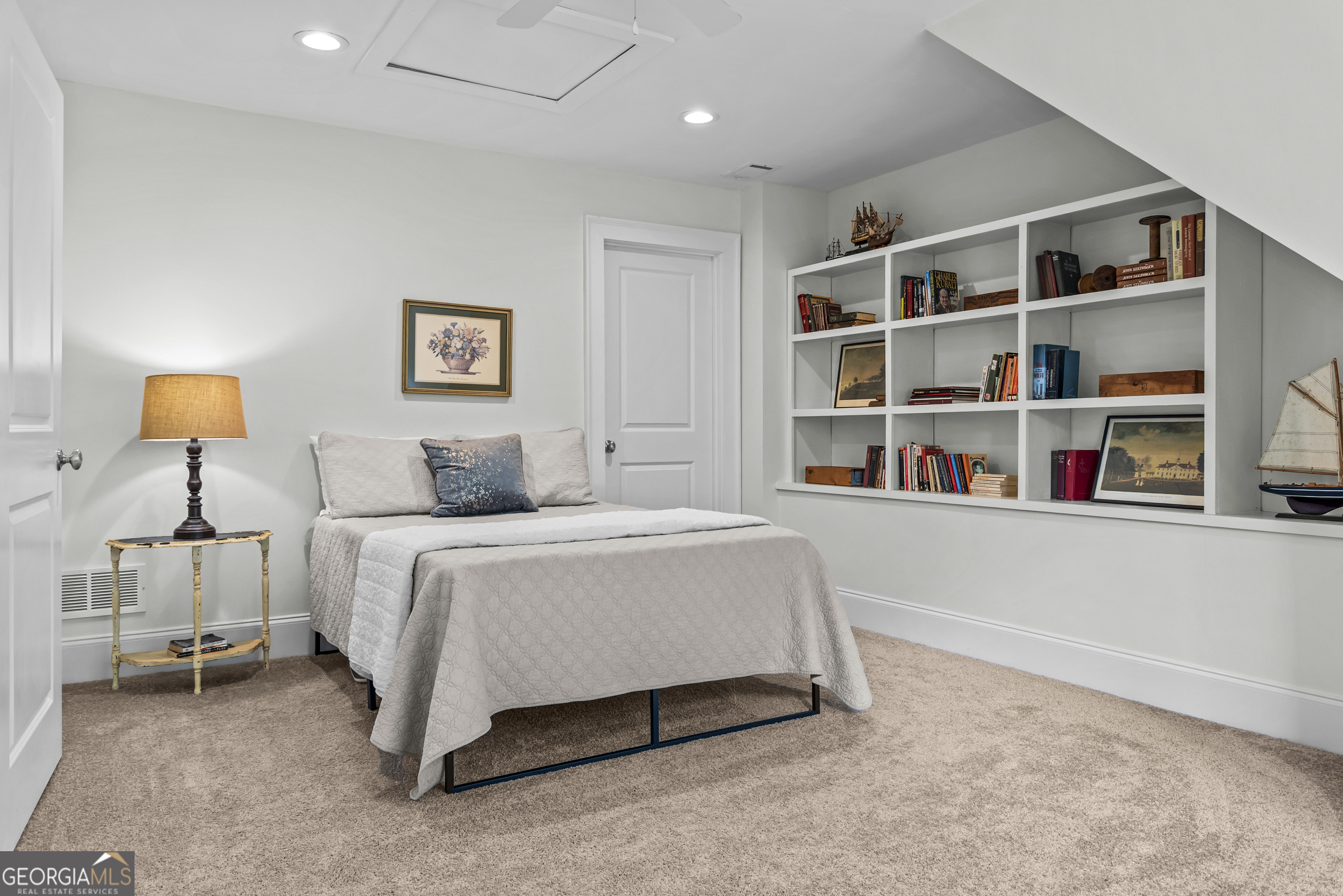 568 New Post Road Madison, GA 30650 - Photo 48 of 58 a bedroom with a bed and a book shelf