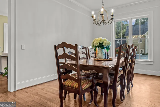 a kitchen with a sink appliances cabinets and wooden floor