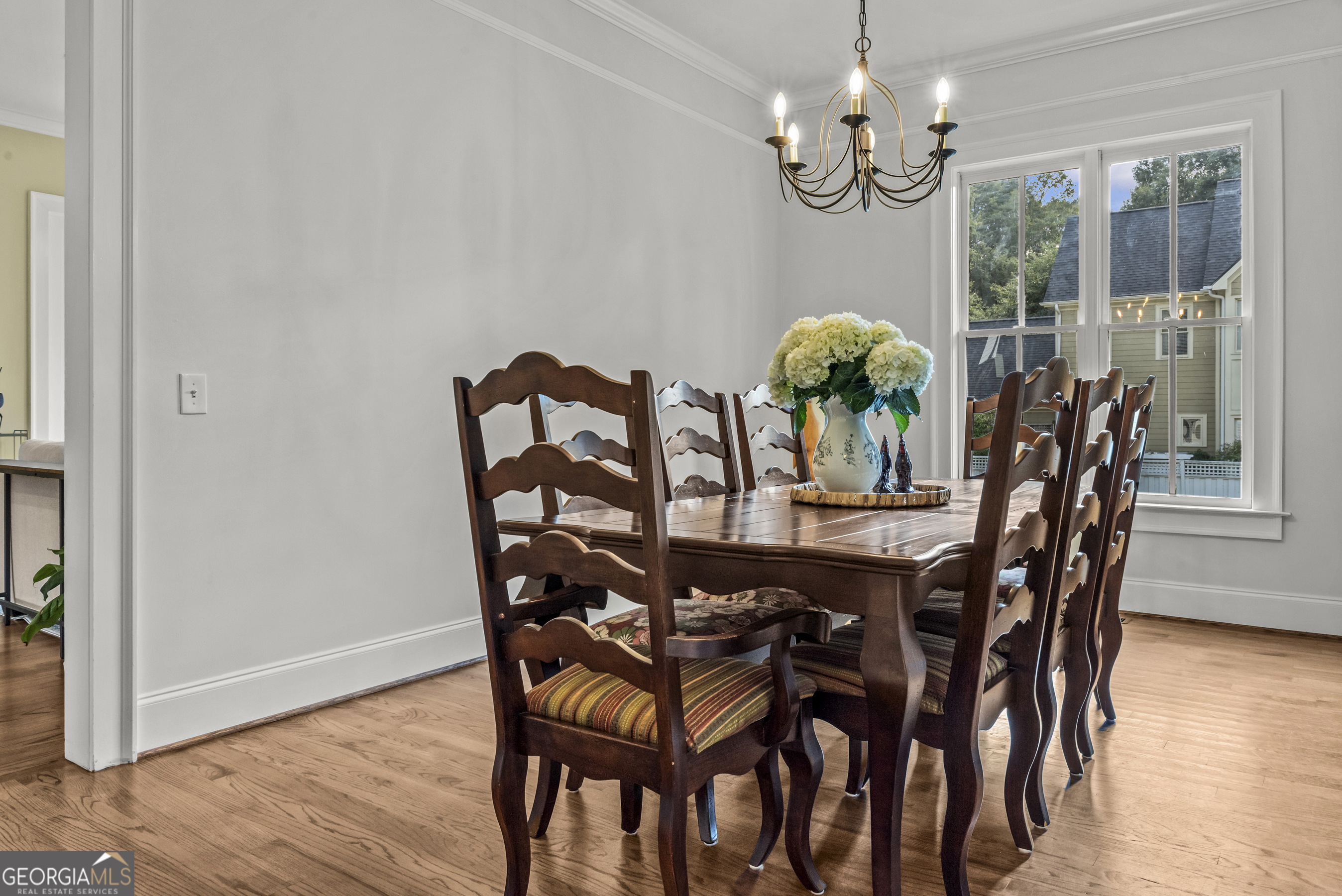 568 New Post Road Madison, GA 30650 - Photo 9 of 58 a dining room with furniture a chandelier and wooden floor