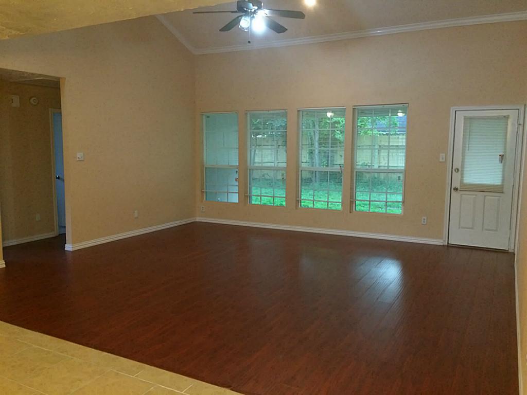 16826 Rippling Mill Drive Sugar Land, TX 77498 - Photo 1 of 18 a view of an empty room with wooden floor and a window