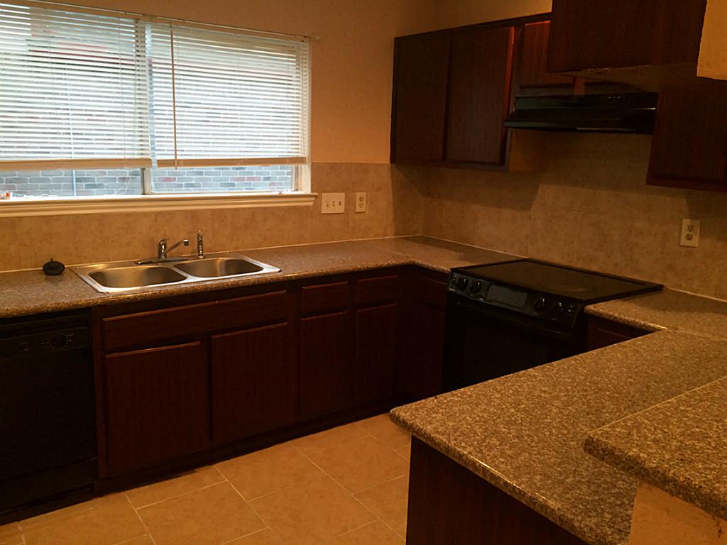 16826 Rippling Mill Drive Sugar Land, TX 77498 - Photo 12 of 18 a kitchen with a sink and a window
