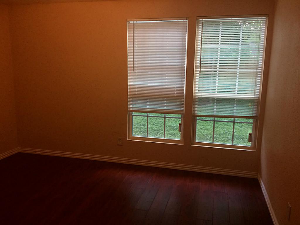 16826 Rippling Mill Drive Sugar Land, TX 77498 - Photo 13 of 18 an empty room with wooden floor and windows