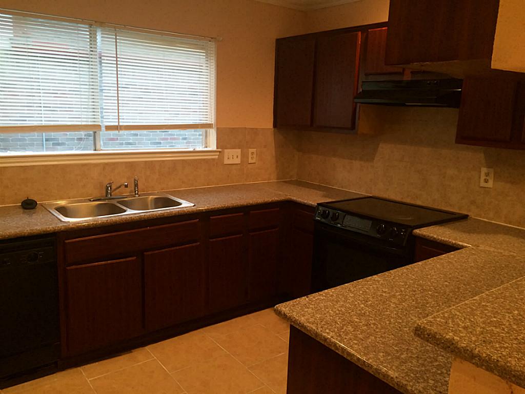 16826 Rippling Mill Drive Sugar Land, TX 77498 - Photo 14 of 18 a kitchen with a sink and cabinets