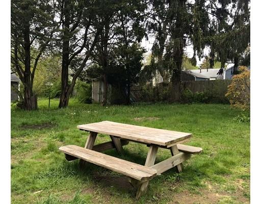 68 Leland Road Marshfield, MA 02050 - Photo 24 of 28 a view of a wooden bench and chairs in the garden