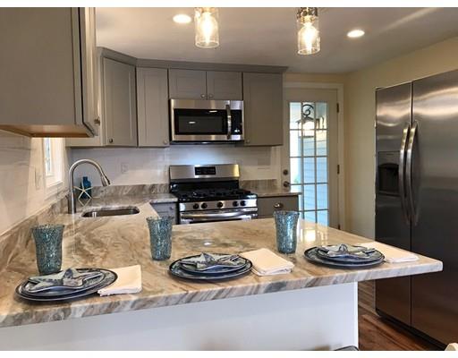 68 Leland Road Marshfield, MA 02050 - Photo 7 of 28 a kitchen with a sink a stove and chairs