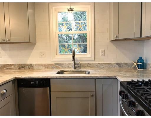 68 Leland Road Marshfield, MA 02050 - Photo 8 of 28 a kitchen with granite countertop a sink stove and cabinets