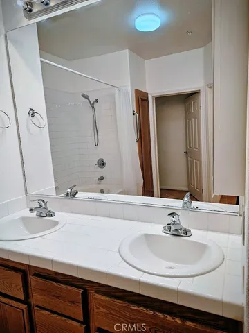 a bathroom with a tub sink and mirror