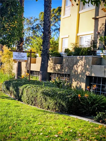 a view of a garden with a house in the background