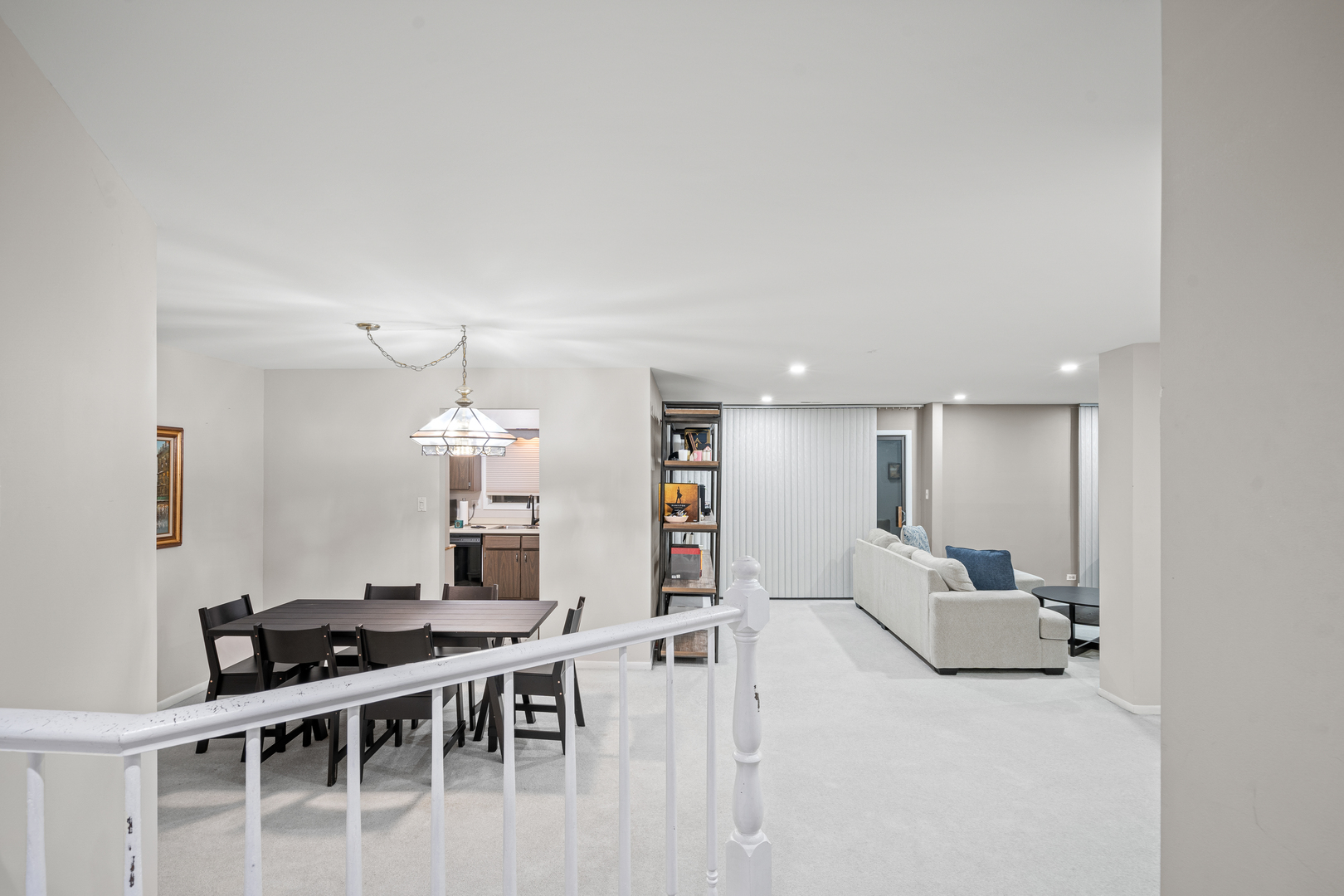 840 Sheldon Court, Unit B Wheaton, IL 60189 - Photo 12 of 13 a living room with furniture a flat screen tv and a table