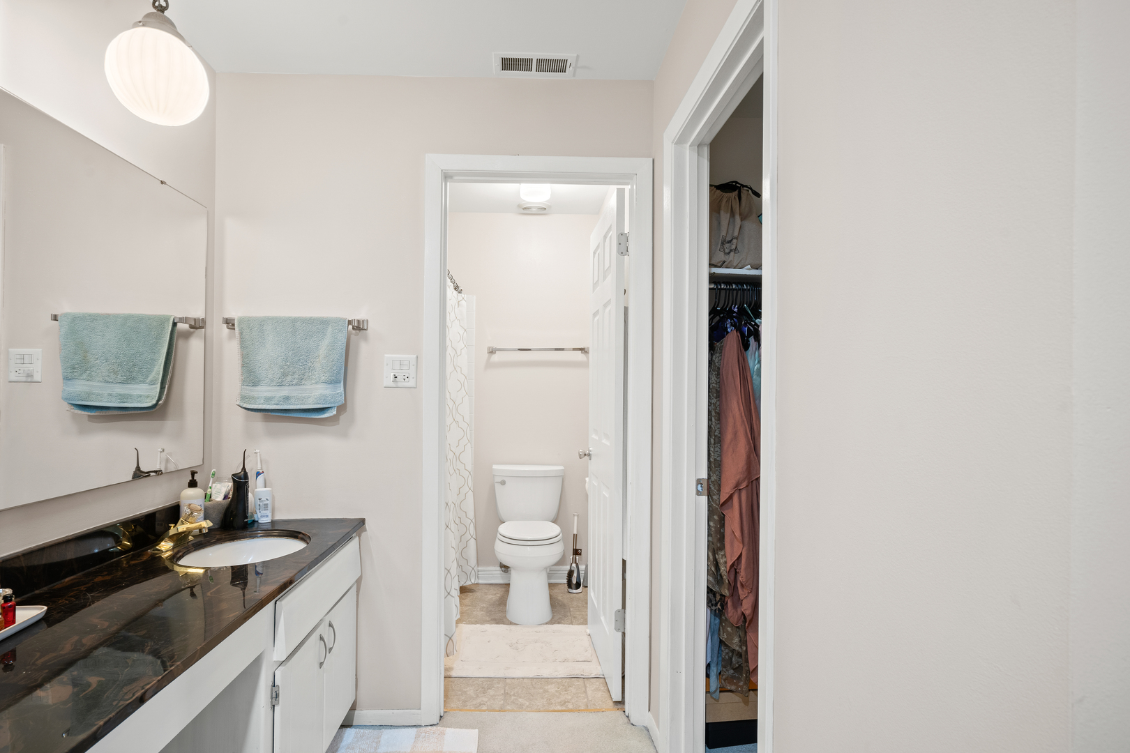 840 Sheldon Court, Unit B Wheaton, IL 60189 - Photo 6 of 13 a bathroom with a granite countertop sink and a mirror