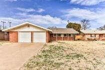 5408 31st Street Lubbock, TX 79407 - Photo 1 of 33 a front view of a house with a yard