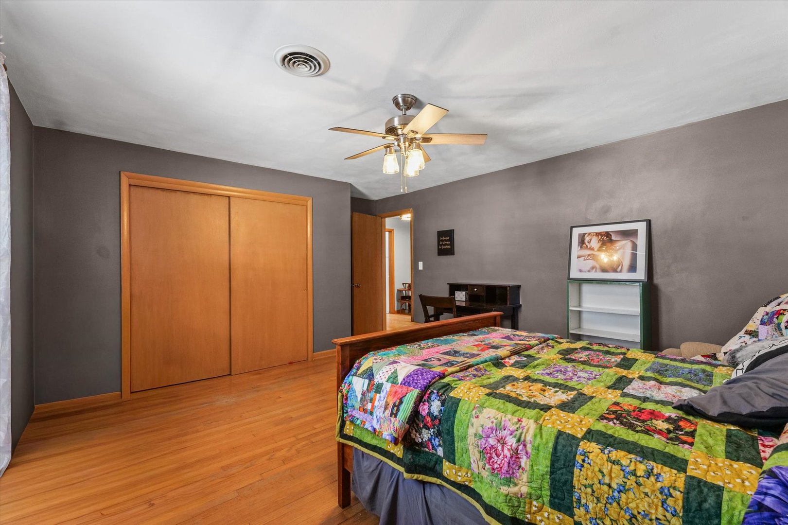 2018 South Cottage Grove Avenue Urbana, IL 61801 - Photo 19 of 31 a bedroom with a bed and a chandelier