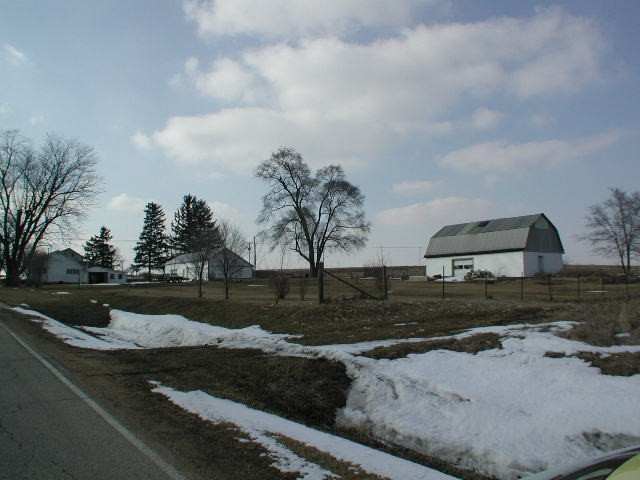 1192 West McConnell Road Freeport, IL 61032 - Photo 2 of 3 a view of a street with a yard