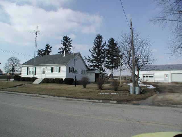 1192 West McConnell Road Freeport, IL 61032 - Photo 3 of 3 a view of a house next to a road with large trees