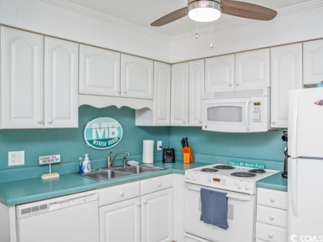 9530 Shore Drive, Unit 2D Myrtle Beach, SC 29572 - Photo 6 of 25 Kitchen with white cabinets, white appliances, ornamental molding, and a ceiling fan