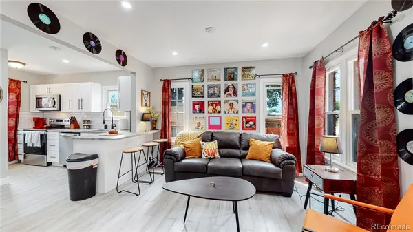 a living room with furniture and a book shelf