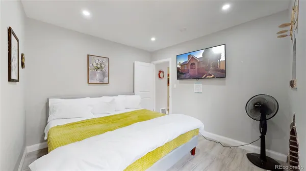 a room with a bed and a painting on the wall