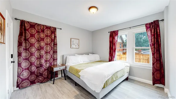 a bedroom with a bed and a window