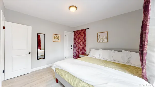 a bedroom with a large bed and a lamp