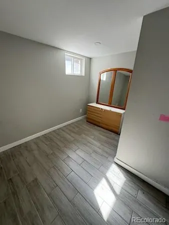 a view of wooden floor and windows in a room