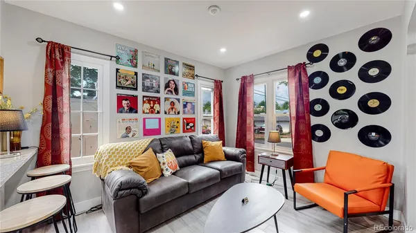 a living room with furniture and a bookshelf