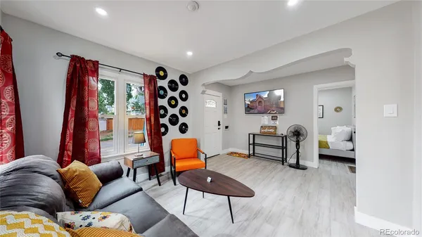 a living room with furniture and wooden floor
