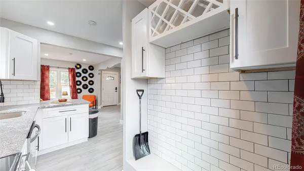 a kitchen with stainless steel appliances a sink cabinets and wooden floor