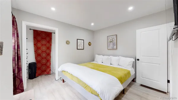 a bedroom with a bed and a lamp