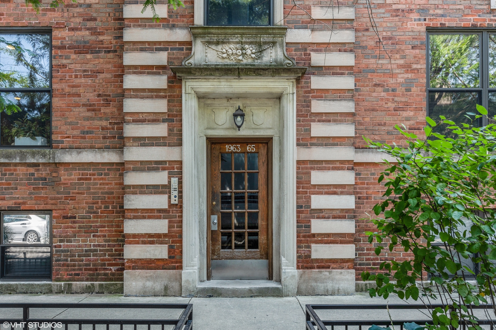 a front view of a building with a garden