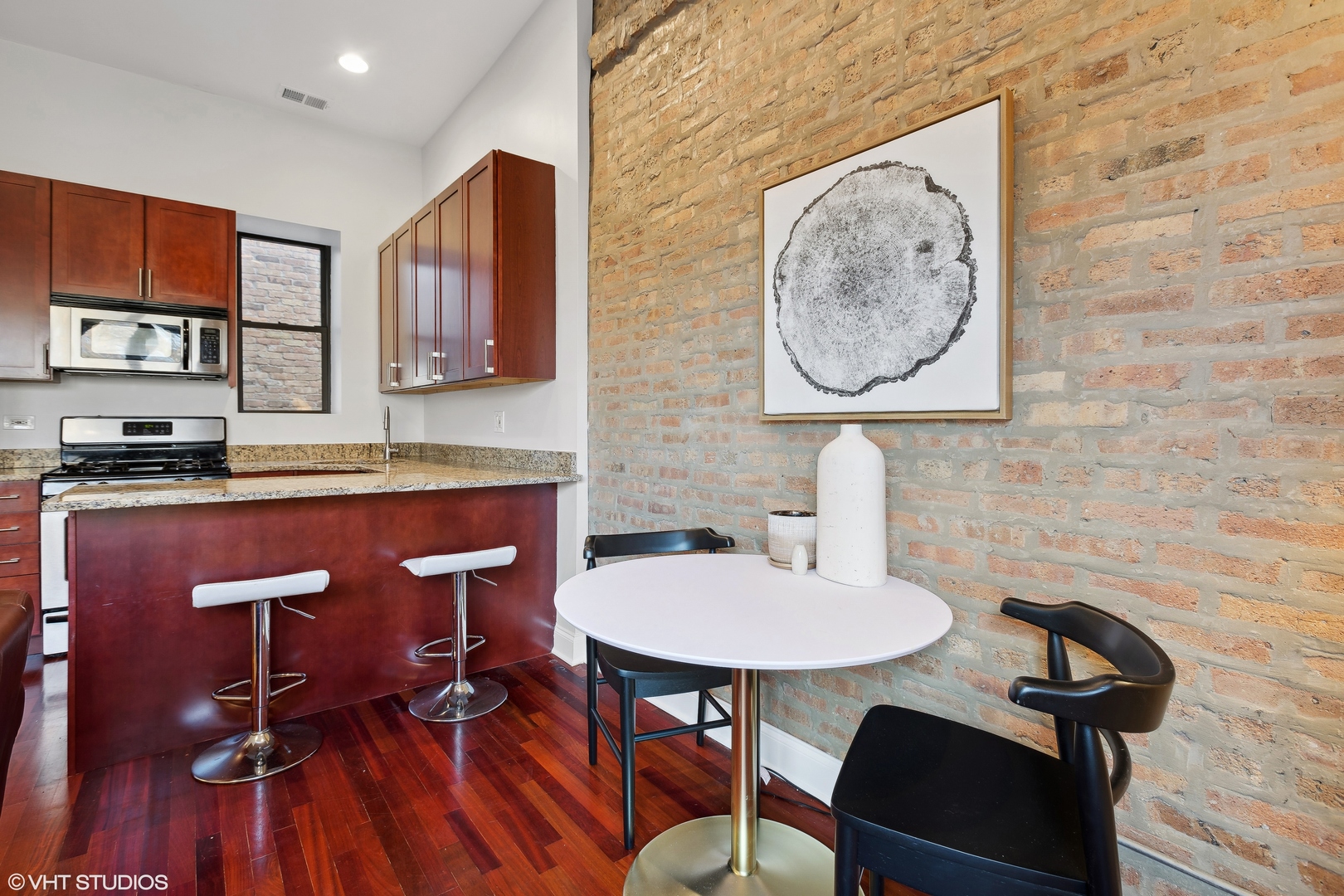 1965 West Cullom Avenue, Unit 3 Chicago, IL 60613 - Photo 7 of 19 a kitchen with a sink a stove and a dining table with wooden floor