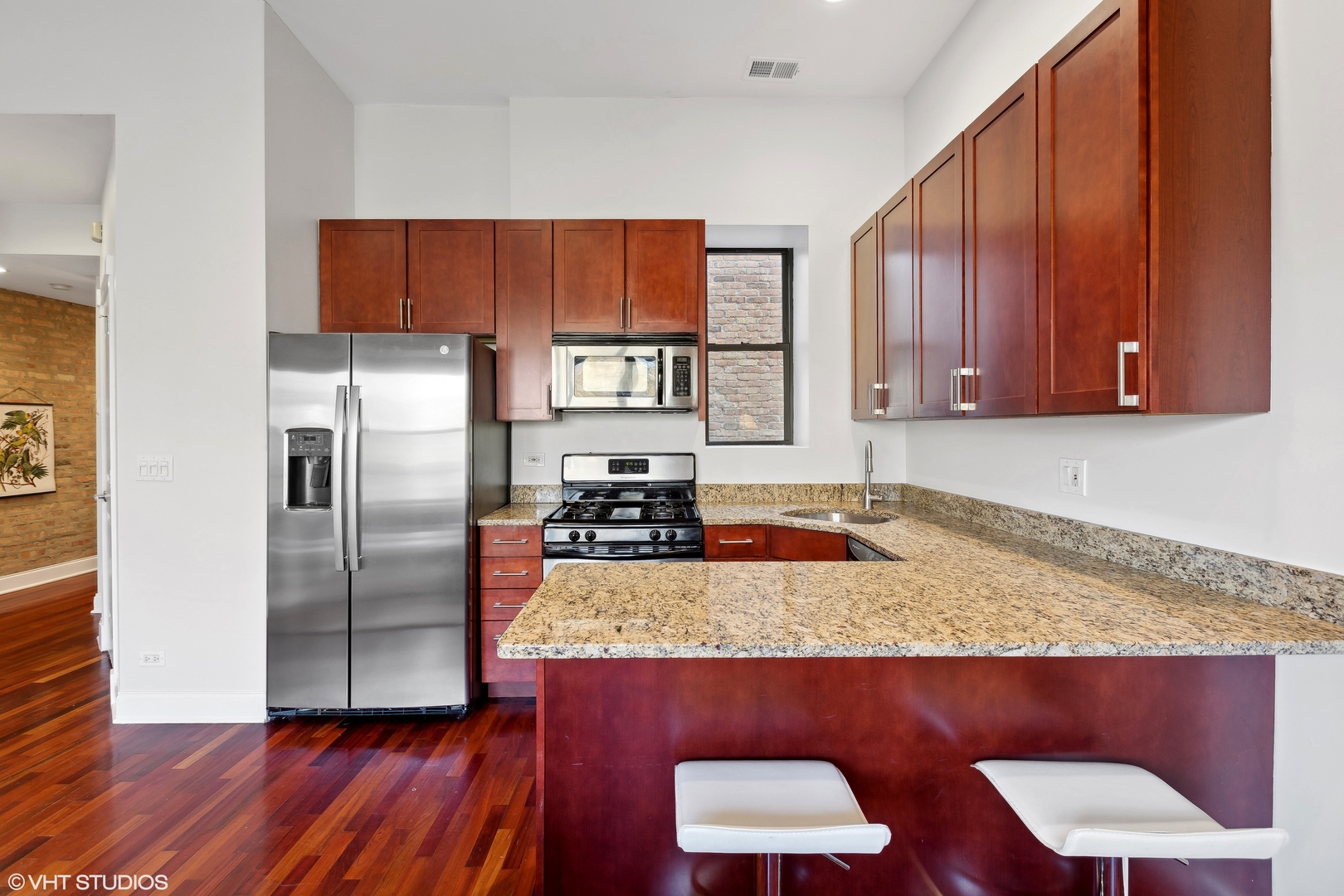 1965 West Cullom Avenue, Unit 3 Chicago, IL 60613 - Photo 8 of 19 a kitchen with kitchen island a counter top space cabinets and stainless steel appliances